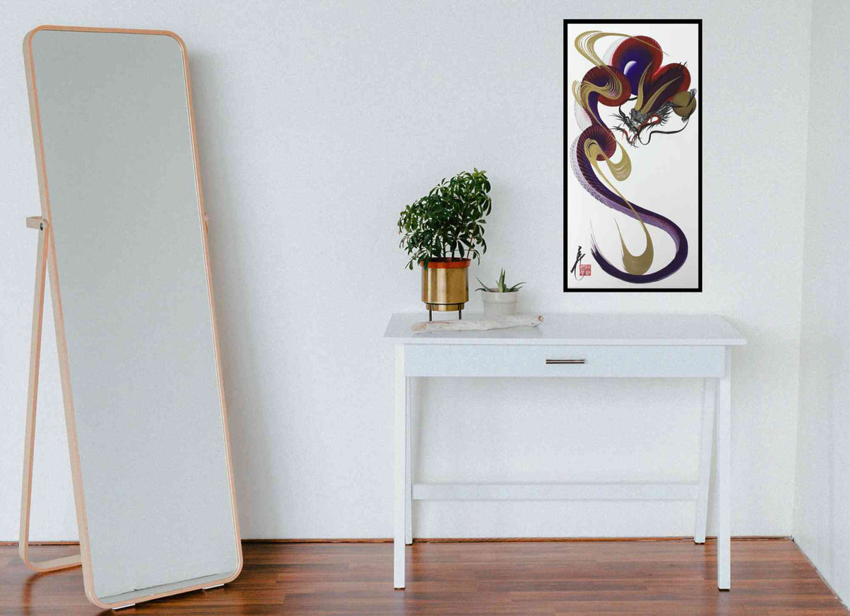 A tall floor mirror with a light wood frame stands on a dark wood floor against a white wall. To the right, a white console table holds a potted green plant, with a framed abstract artwork hanging on the wall above.